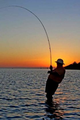 Man fishing at sunset in Ambergris Caye – Best Places In The World To Retire – International Living